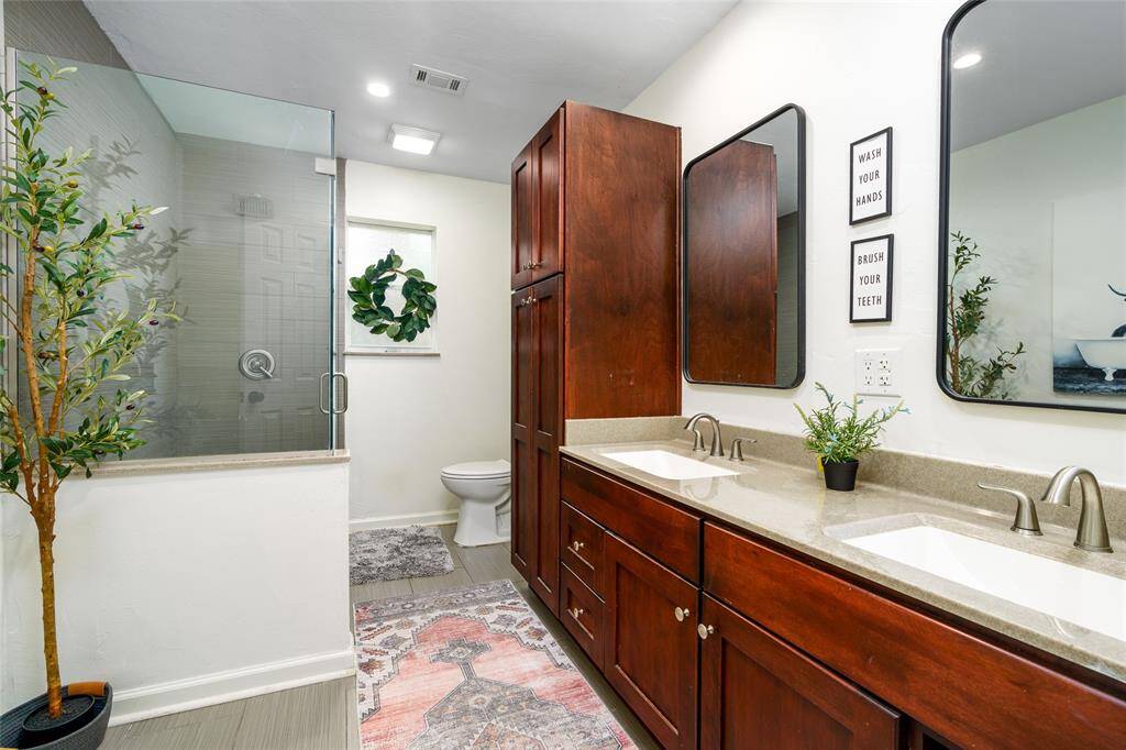 Secondary full bath with stand up shower and double sinks.