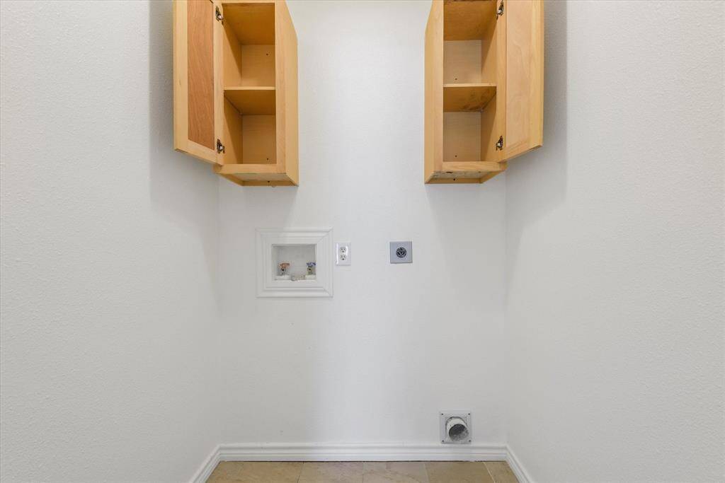 Washer/dryer connections ready with storage
