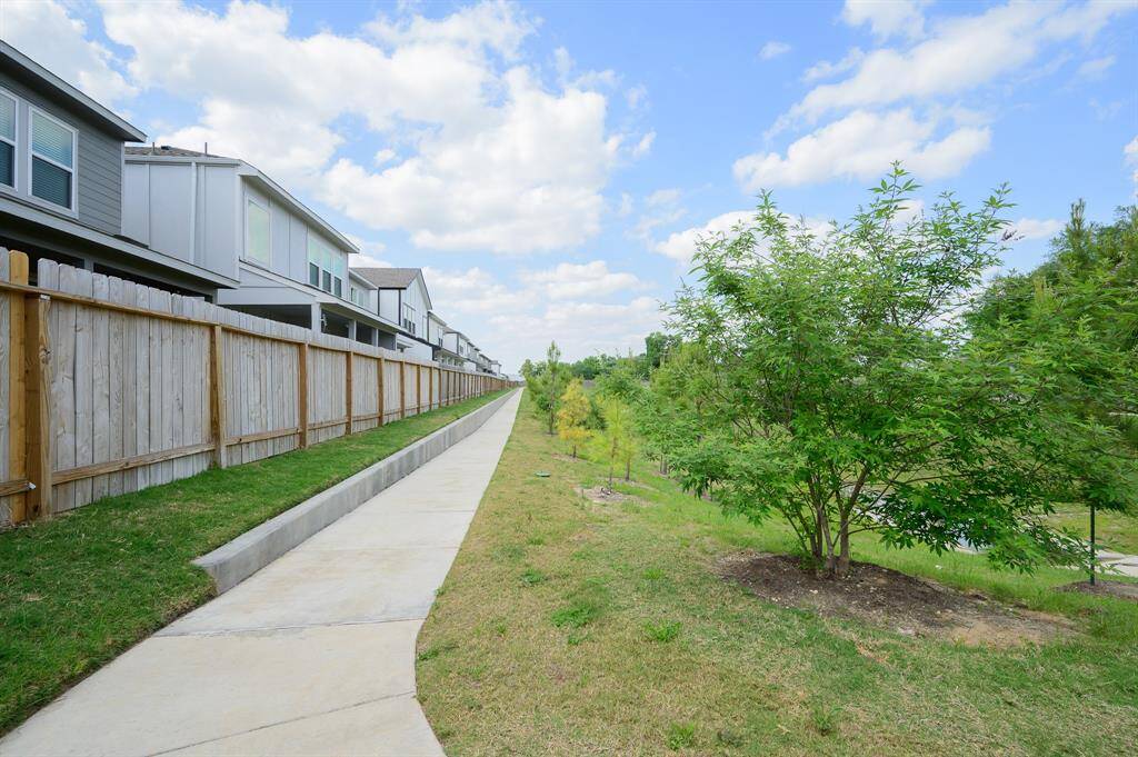 Discover tranquility with a charming walking trail right behind the property, set amidst lush greenery and trees, blending suburban comfort with natural beauty.