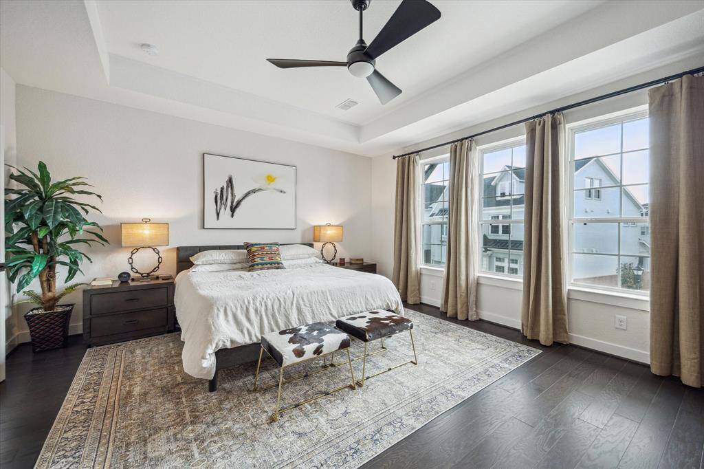 This inviting space features a generously sized bedroom with ample natural light, a walk-in closet, and a luxurious en-suite bathroom complete with dual vanities, a soaking tub, and a separate glass-enclosed shower.