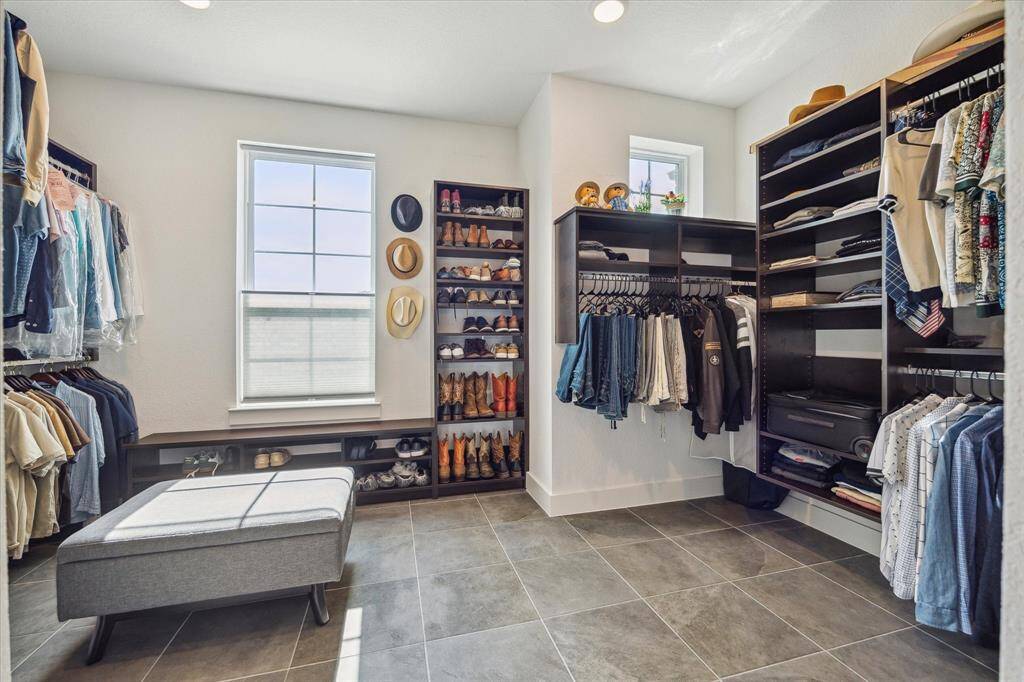 The primary suite features a spacious walk-in closet designed to keep everything beautifully organized. With custom shelving, ample hanging space, there's a dedicated spot for every wardrobe essential—from everyday wear to seasonal storage.
