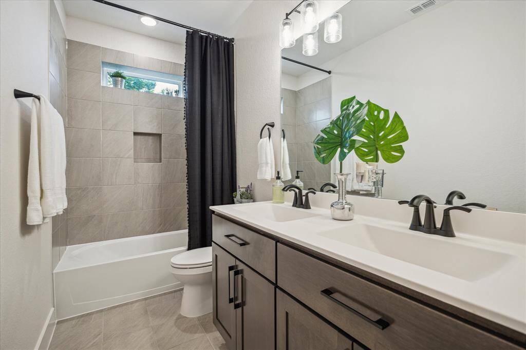 The full bathroom on the second floor features dual vanities.