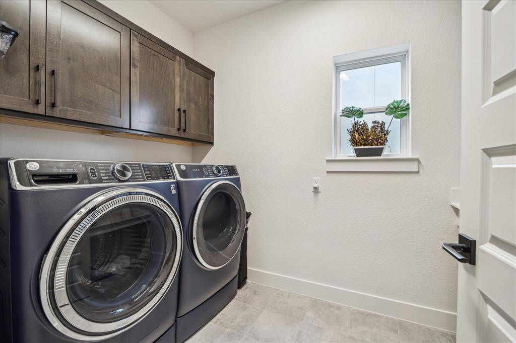Spacious laundry room with built-in and hanging space.