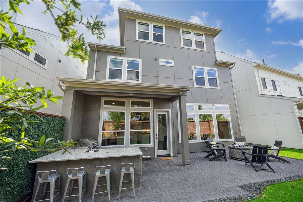 Extended Patio & Custom Luxury Outdoor Kitchen–featuring bar seating.