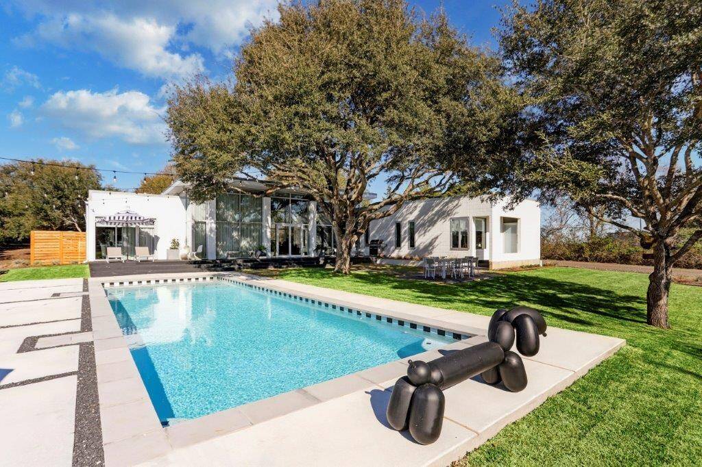 Serene sanctuary, heavenly haven, modern masterpiece...yes, this showstopper is in Bellville, TX! 5 perfectly manicured acres equipped with a 4 bedroom/3 bathroom contemporary home, sparkling pool (resurfaced in 2022), bocci ball court, fire pit, generator, & 3 stall barn; this is IT!