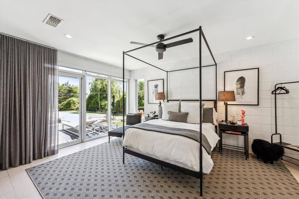 Situated privately from the other 3 bedrooms, the primary suite is a relaxing sanctuary. Enjoy the luxury of waking up to the poolside views (and access) every day from your bedroom.