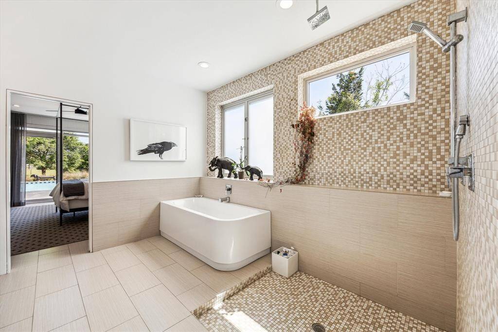 This rectangular free-standing tub is not just a functional element but a stunning focal point, perfect for relaxation and calm. Even the bathroom is filled with natural light!