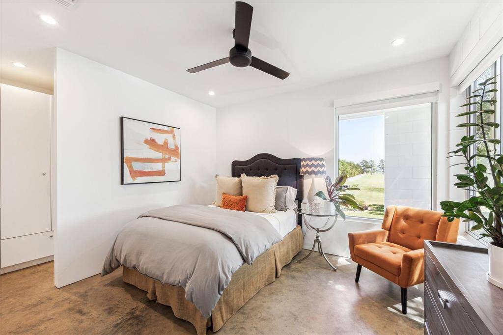 This guest bedroom is situated on the back corner of the home with views overlooking the pool and the huge stretch of lawn as you enter the property.