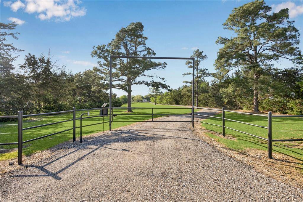 A classic gravel entry includes an automatic driveway gate. The home is set back approximately .2 miles from the road.