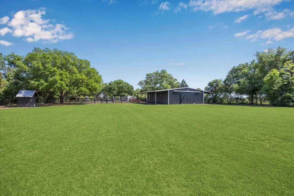 This is a view of the back pasture looking toward the back of the barn and front of the home.