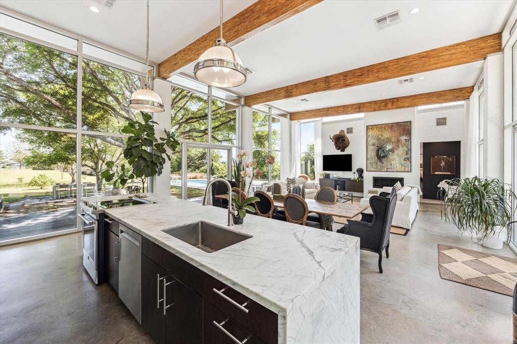 Entertaining at its best, the modern, open-concept space spans nearly 40 feet and is designed for ultimate enjoyment. The walls of glass allow for a seamless flow of indoor - outdoor pleasure.