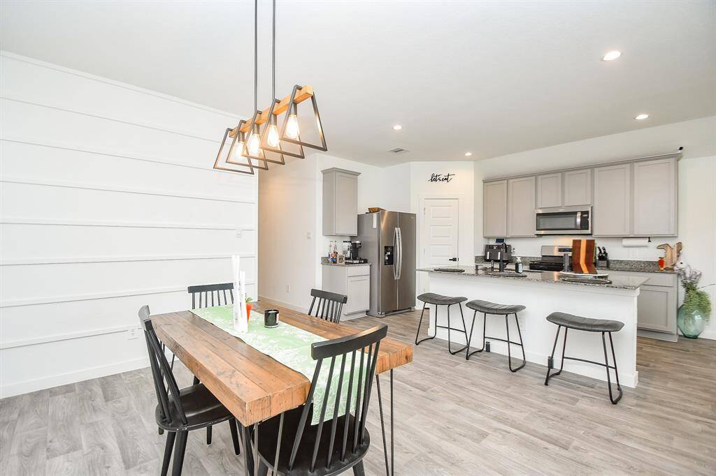 Dining area with upgraded lighting and designer wall feature