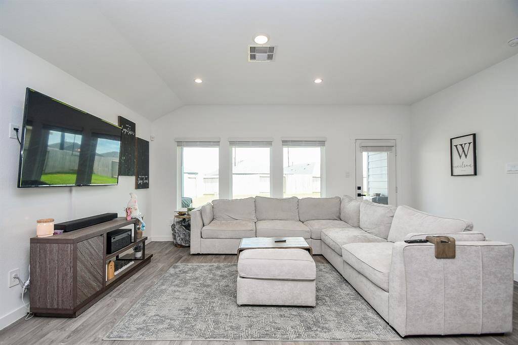Living room has ample natural light from the wall of windows