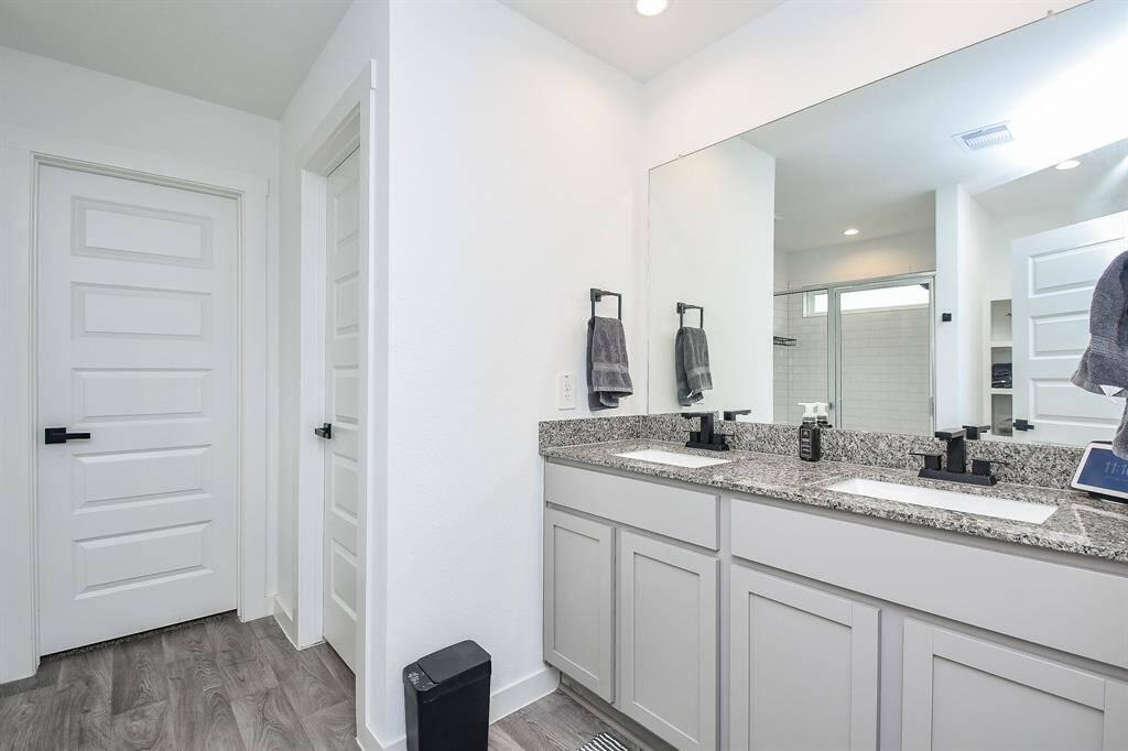 Double sink vanity with granite counters in primary bath