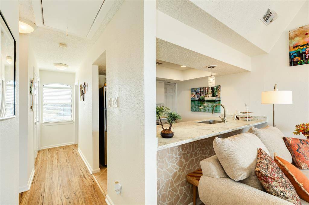 Back down this hall on the top level, you'll notice the utility closet on the left and a full secondary bath on the right. The window overlooks the golf course and wetlands.