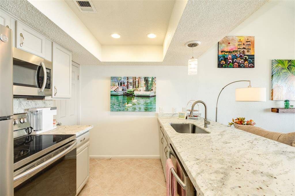 Leathered granite, stainless steel appliances, custom cabinets, bright, water views from your kitchen sink, and a spacious pantry all await you.