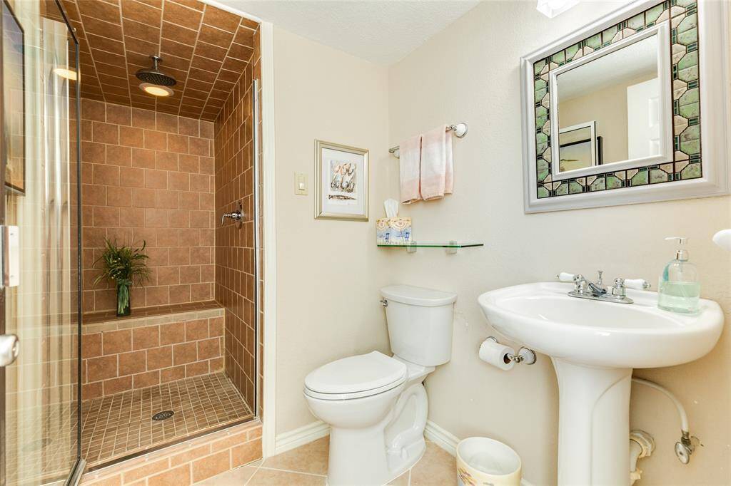 The large, shower with built-in seating and rain shower head make this full bath on the top level a special treat.