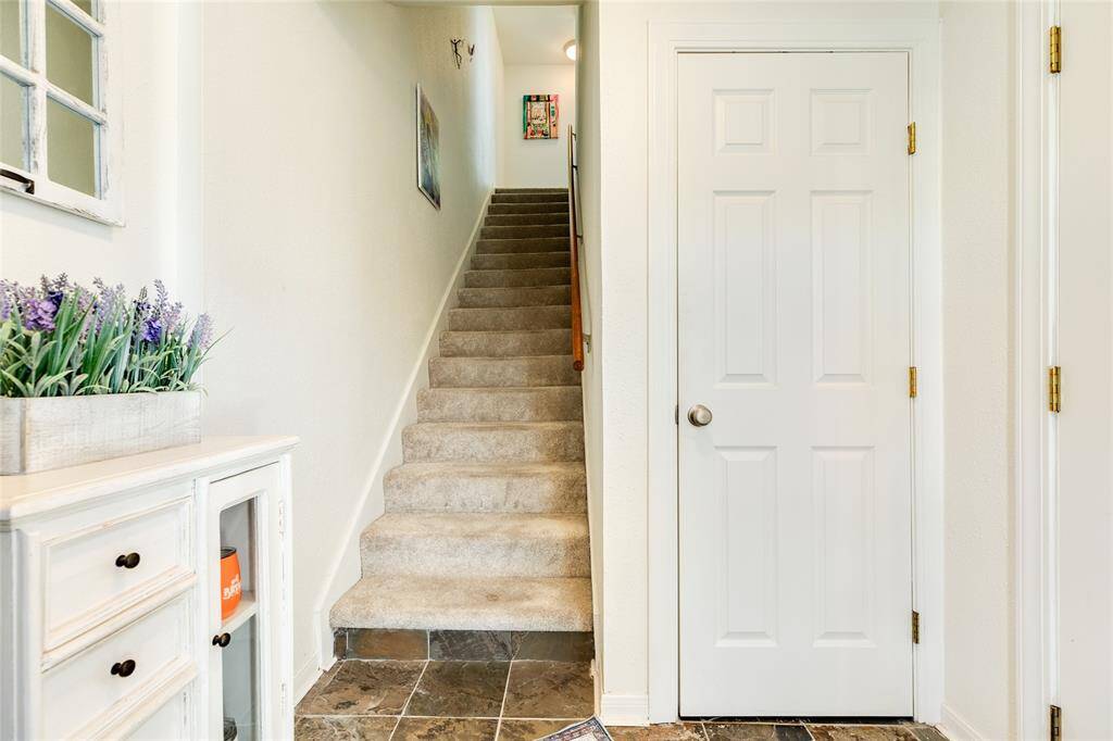 This ground level entry features custom slate tiles and a coat closet. The door on the right goes out to the garage.