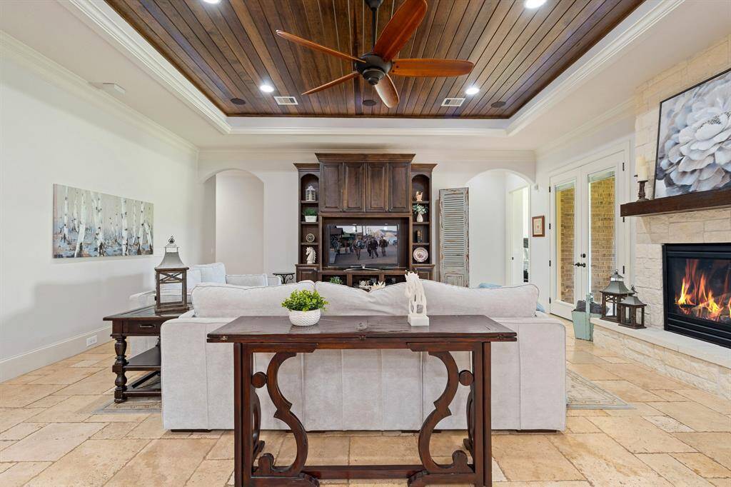 With the Primary Bedroom through the arched walkway to the right, and three Secondary Bedrooms located through the archway to the left, all accommodations reconvene in this spacious and centrally located Living Room.
