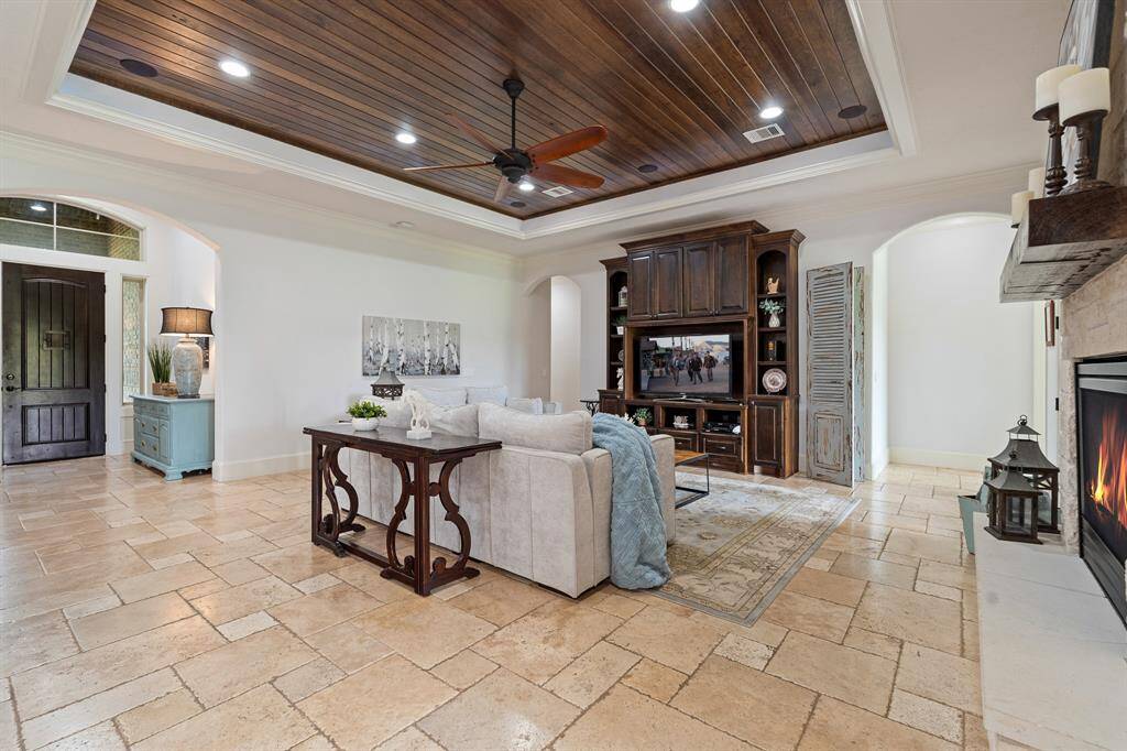 The wood paneled ceiling is home to built-in speakers, taking your movie watching to a whole new level. The space is large enough to accommodate a multitude of seating arrangements and can even house additional storage options.