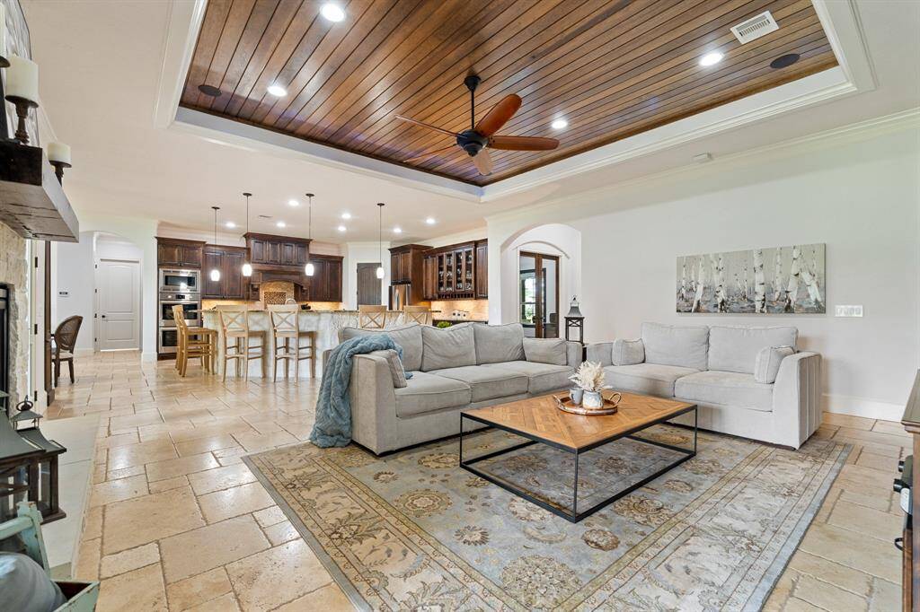 Notice how the Traveterine flooring traverses the entire living area. With an open concept design like this, it is important to have consistencies that tie the different spaces together.