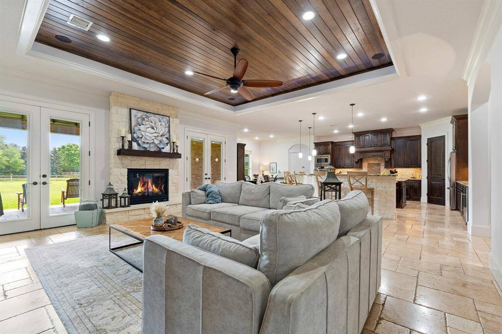 The Living Room and Kitchen feel big and bright thanks to the abundance of natural light that fills the space through the pair of glass-plated double doors on either side of the fireplace, and wall of windows in the Breakfast Room.