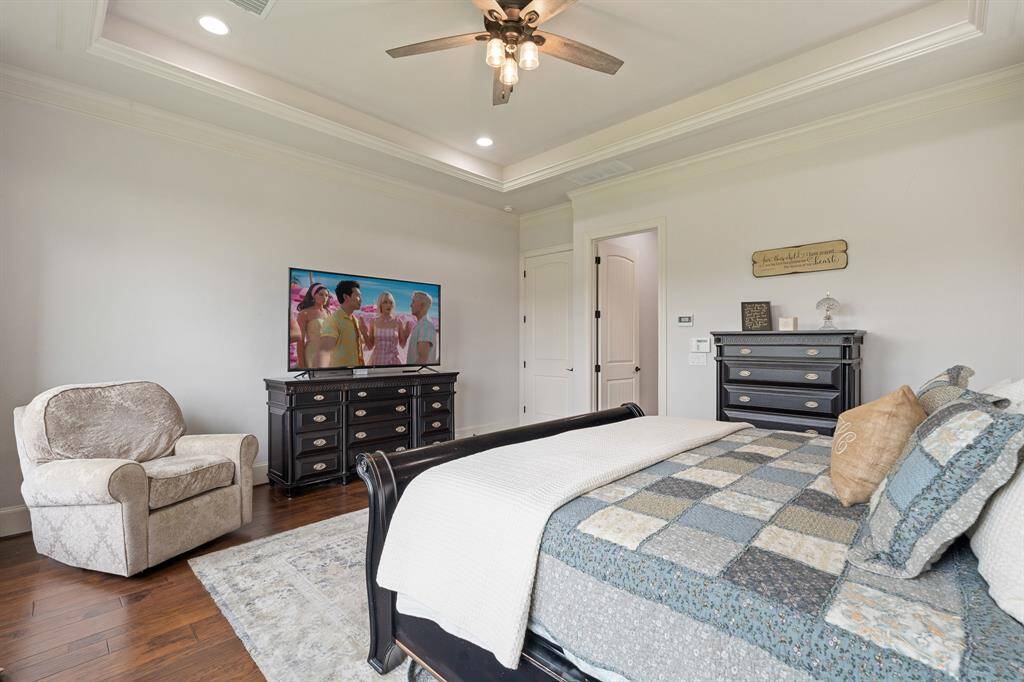 The tray ceiling adds a formal flair, and boasts recessed lighting, as well as a 5-blade ceiling fan. With the room being so grand in size, the space can easily accommodate additional furniture like a dresser, small desk, or cozy seating.
