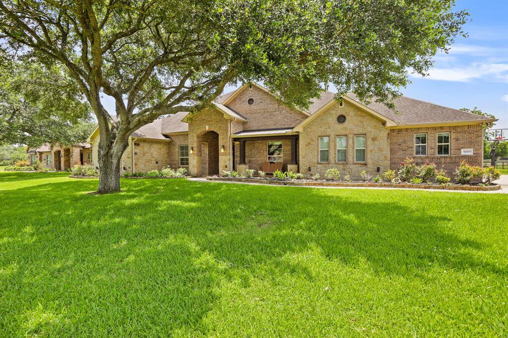 The front walkway leads guests past an array of low maintenance shrubs and plants, that boast a pop of color most of the year, on their way to the home’s front door and extended porch. Add a porch swing or two rocking chairs and relax while watching the kids play out front.