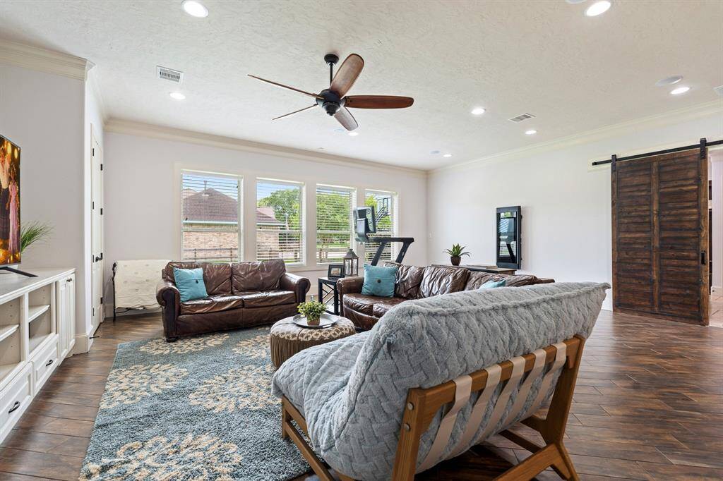 Four cased windows overlook the home’s large side-yard and provide welcoming natural light. This space can house a pool table, comfy couches, toys, or even workout equipment. This spacious room is ready to service you however you need.