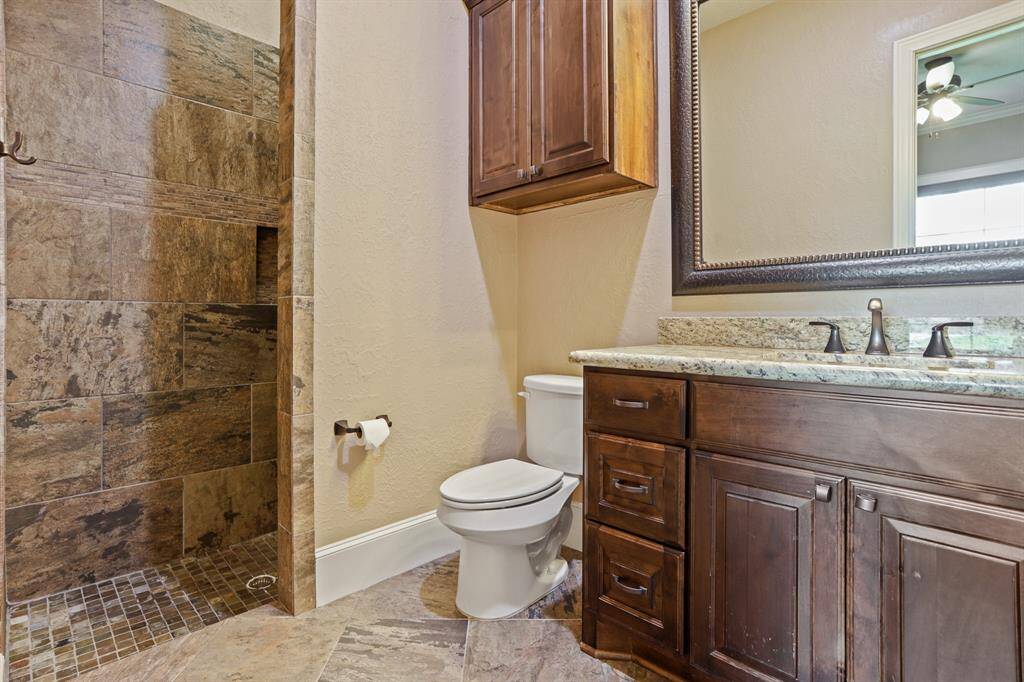 The prior Secondary Bedroom has direct access to this ensuite Bathroom. Equipped with an undermount sink, granite countertop, above and below storage, and walk-in, frameless shower, this space is sure to suit your family’s needs.