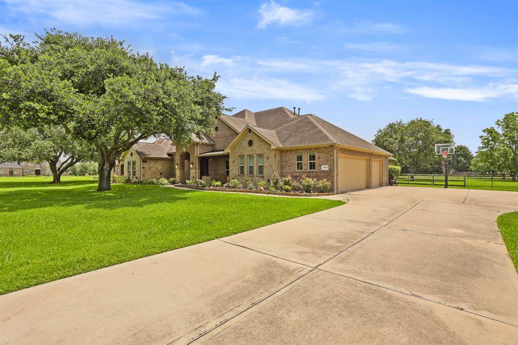 An extra-wide driveway leads to the home’s 3-car garage, and also provides a safe place to shoot hoops, ride bikes, or skip rope. The extension at the end of the driveway also offers space for additional parking when entertaining.