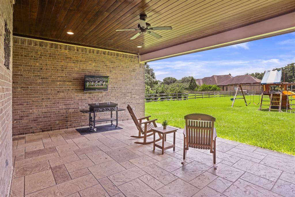This Backyard Patio is grand in both size and function. The low maintenance floors keep the space slip-free and easy to wash down. The wood paneled ceiling mimics the one found in the Foyer and Living Room, continuing that attention to detail and consistency.