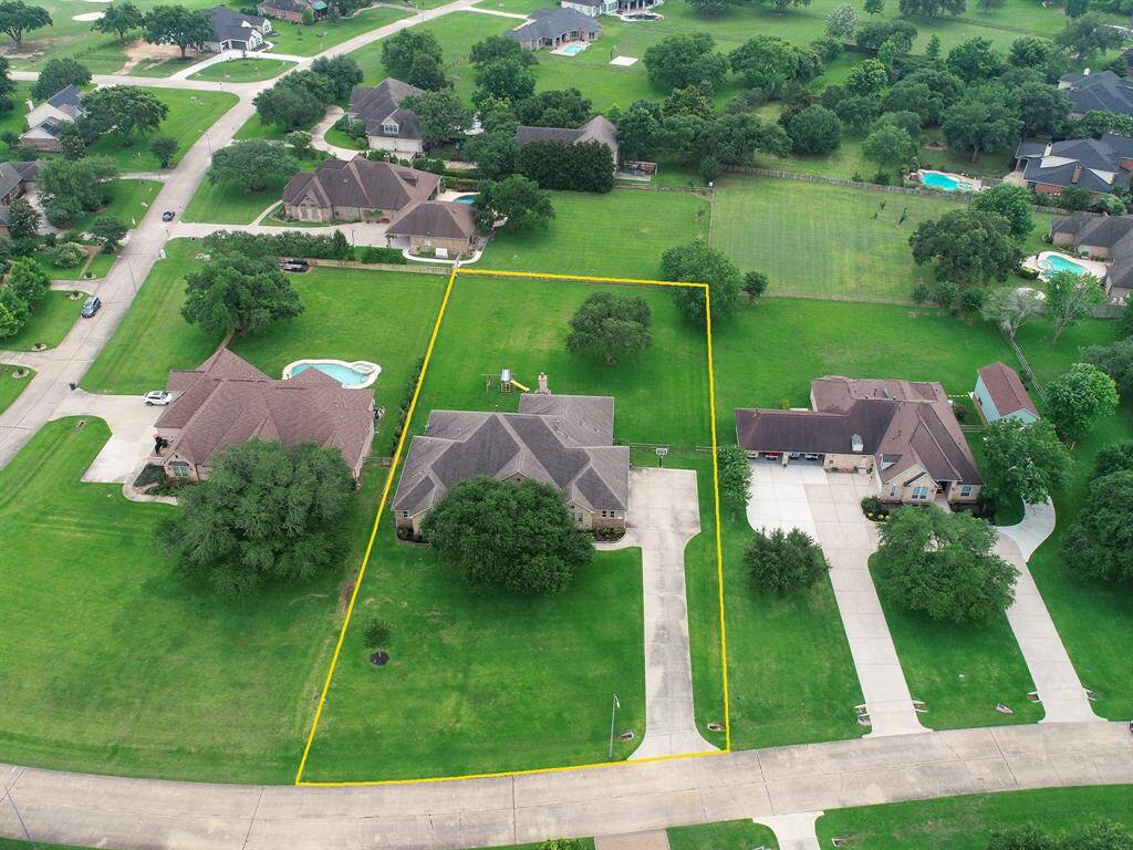 This bird’s eye view showcases the homes spacious one acre lot on this quiet, country street. The home’s central location makes for both a large Front and Back Yard. Space like this is hard to find anywhere else!