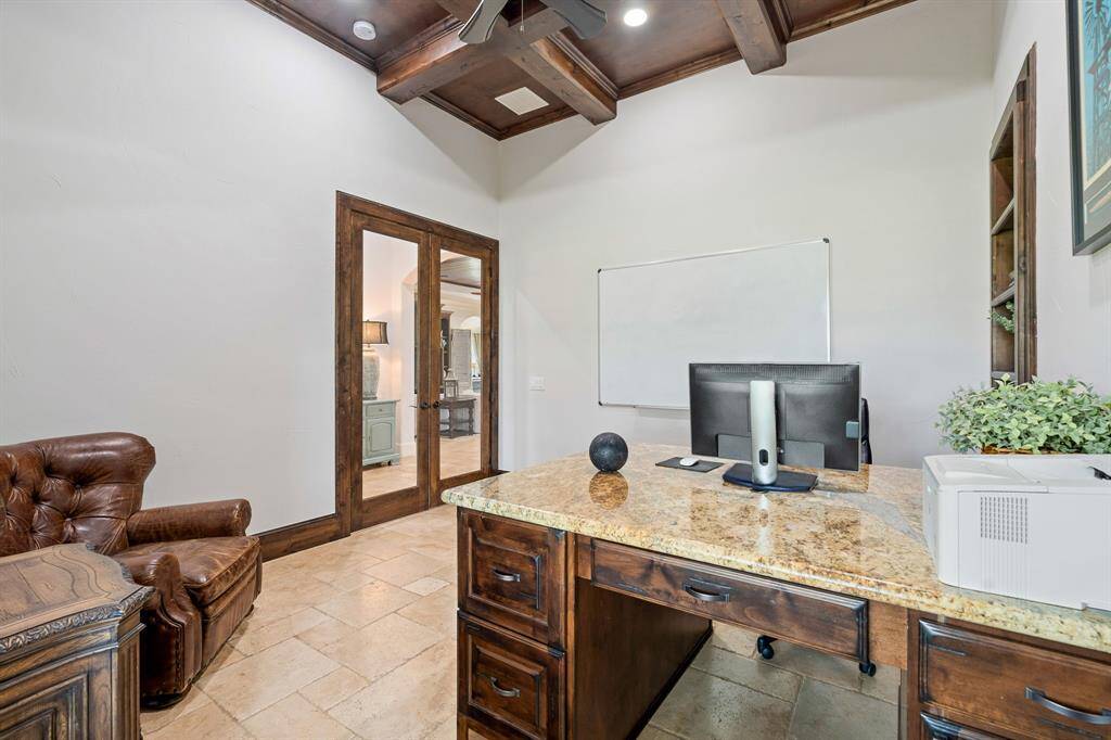 The glass-plated double doors provide a sense of privacy, while still maintaining an open and approachable feel to the Foyer just beyond. With the room being so large, the space can easily accommodate additional seating and storage to help you stay tidy and organized.