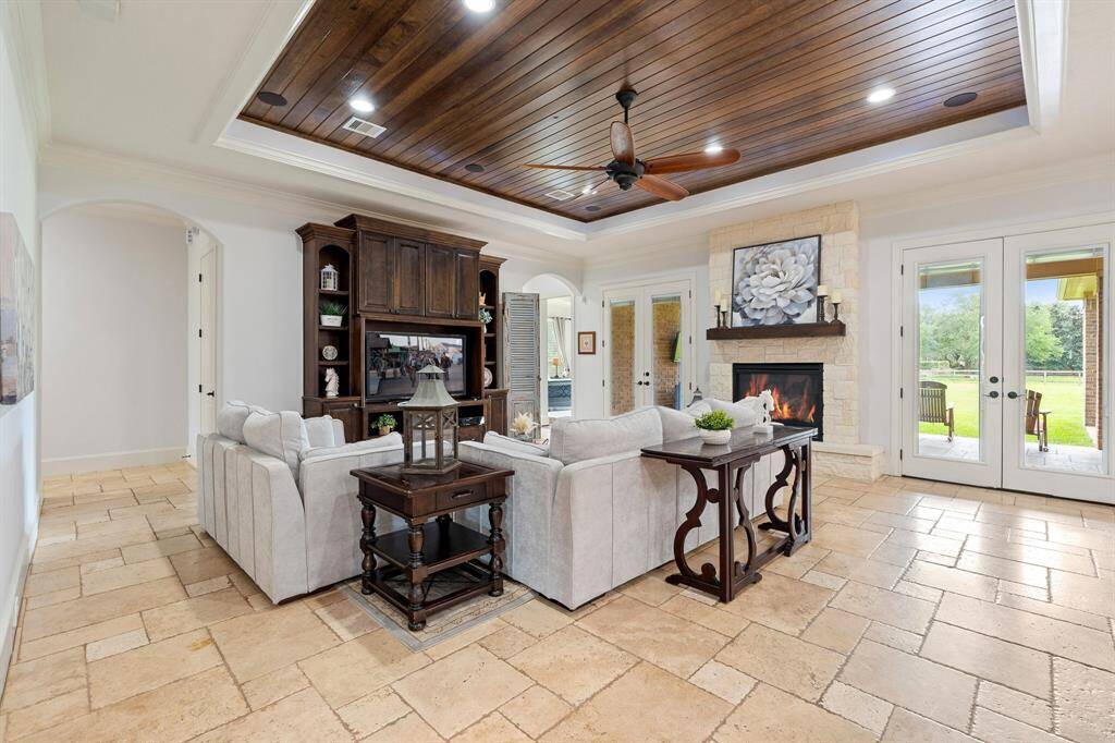This spacious Family Room acts as the anchor of the home, thanks in large part to its direct access to just about every room of the home. The crown molding with wood paneled tray ceiling draws the eyes upward and adds an understated elegance to the space.