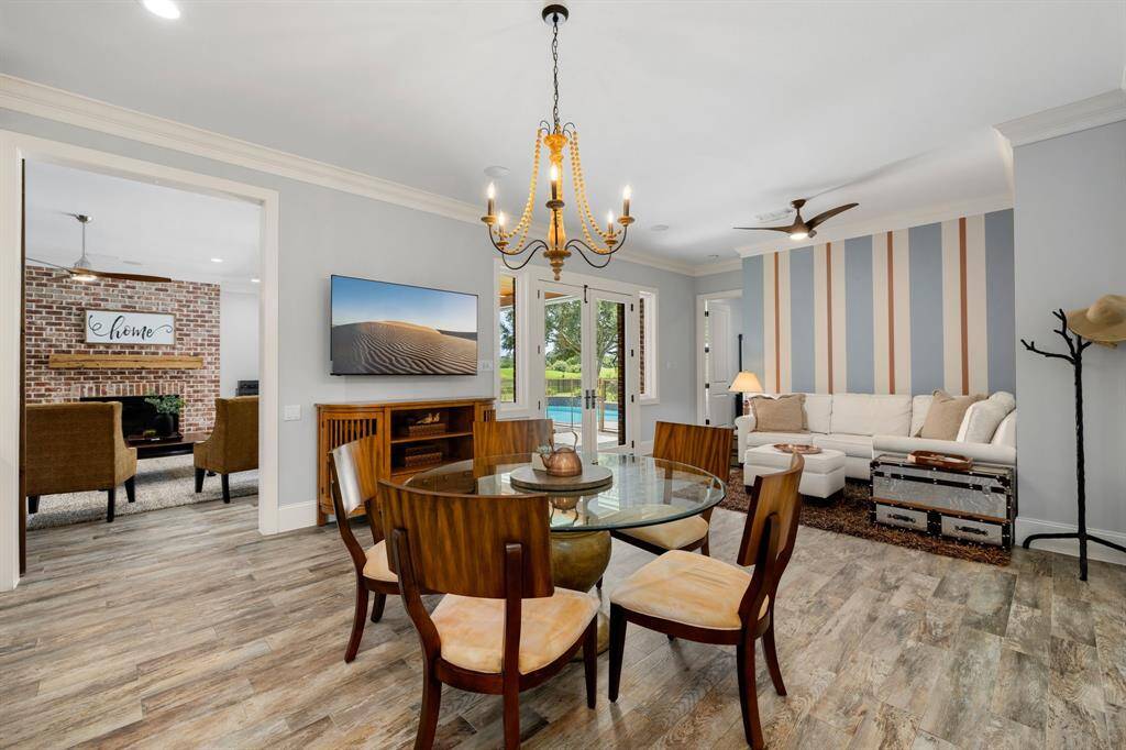 The breakfast area is anchored by a statement chandelier and provides the perfect flow from the family room to the kitchen and sitting area.