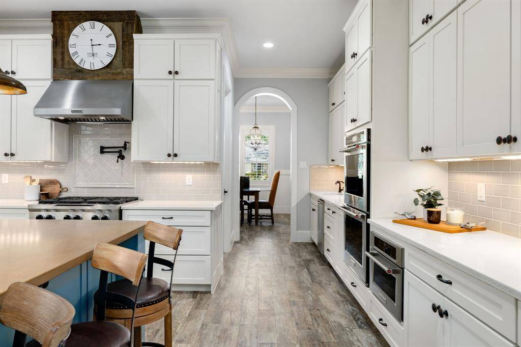 The penny stained concrete island and quartz counters are a statement and complimentary of each other in this oversized kitchen. The quartz counters continue into the butler pantry and dining making this an entertainers dream.