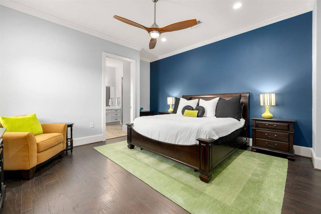 Third downstairs primary suite with recessed lighting and views of the backyard.