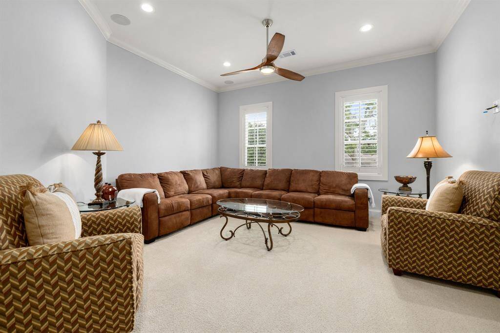 This sitting area/second living room/game room is an inviting and cozy flex space. Large windows flood the area with natural light.