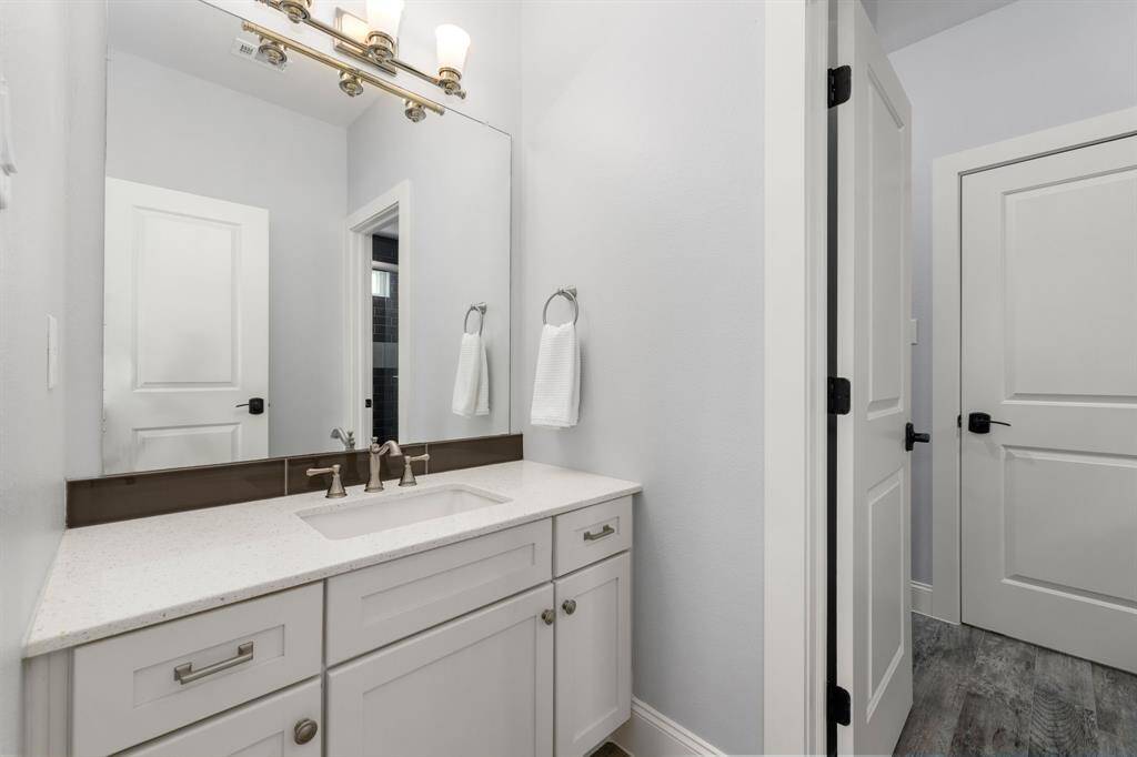 Separate vanities for the jack and jill bathroom between two secondary upstairs bedrooms.
