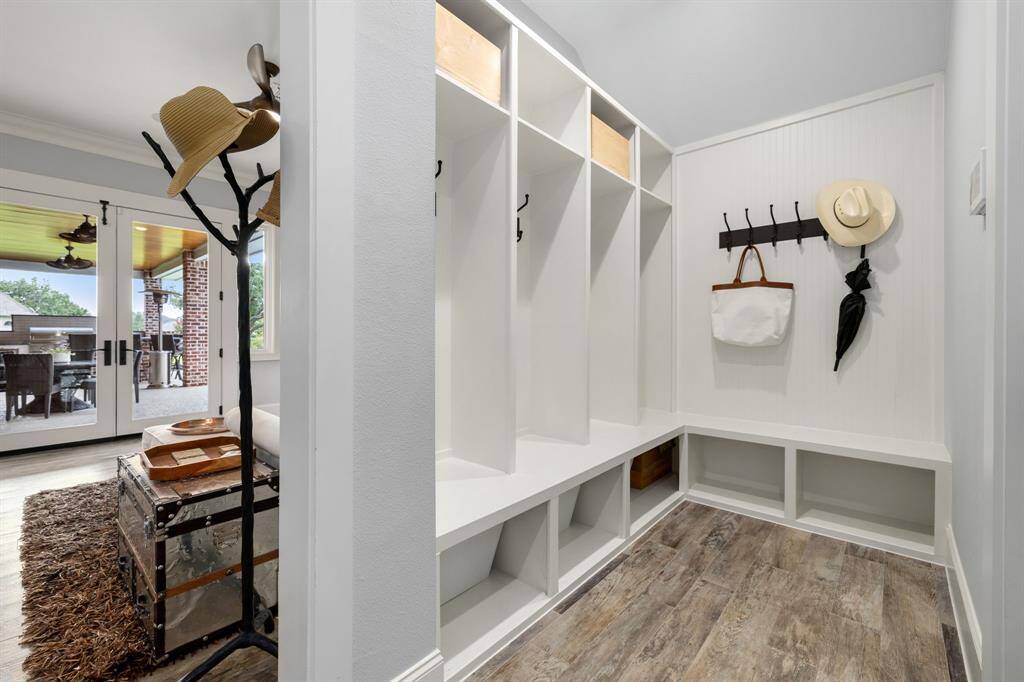 Conveniently situated right inside the door leading in from the 4-CAR oversized garage, the mudroom serves as the perfect drop zone to help the rest of the house remain organized and clutter free.
