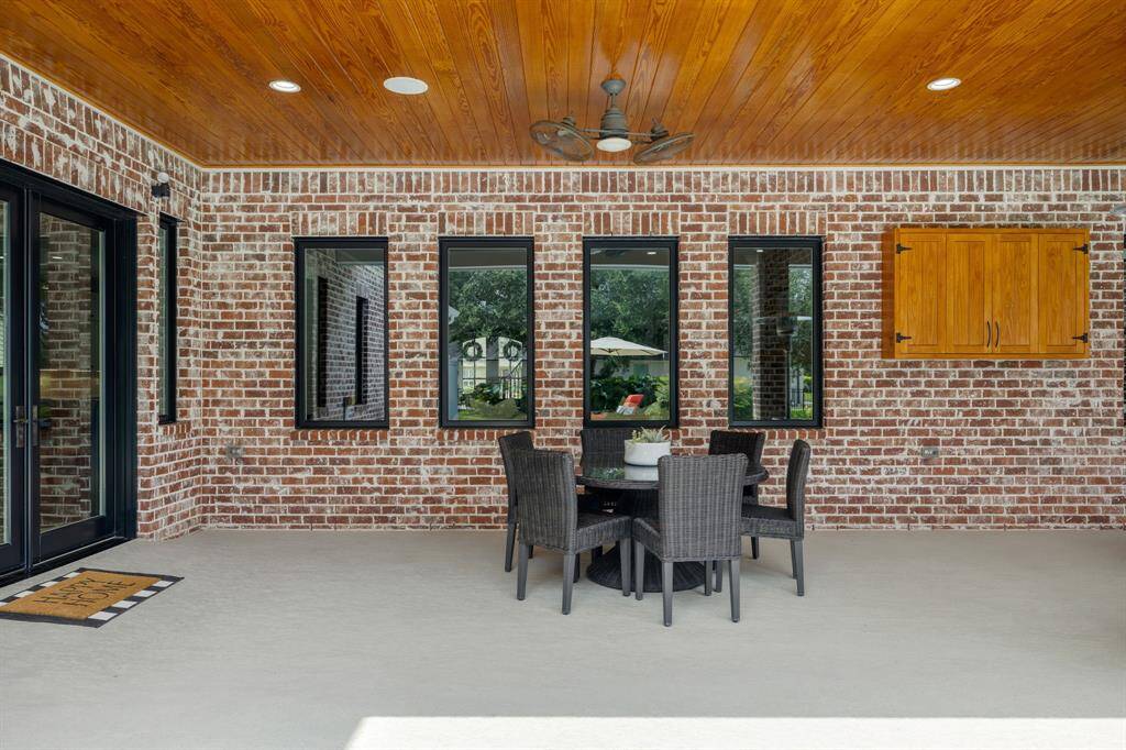 Beneath this covered patio, you will find built-in speakers and ceilings fans adding to the ambience and comfort of the space. With ample room for dining or living, its the perfect spot for hosting gatherings or simply unwinding outdoors. Additionally, there is a built in TV cabinet.