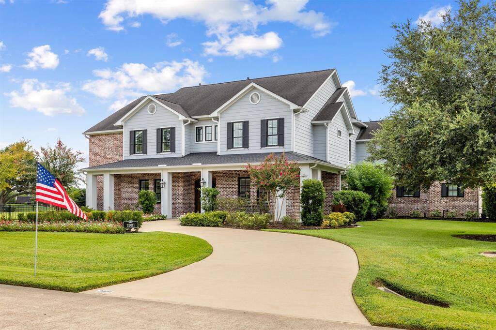Traditional red brick and craftsman flare are combined to make this a stunning elevation. Circular front driveway. Home sits on a double-lot totaling 1 acre and is located on a corner lot and quiet cul-de-sac street with so much space between neighbors.