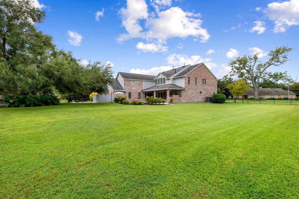Expansive 1 acre property with iron fence all the way around the combined 1 acre property.