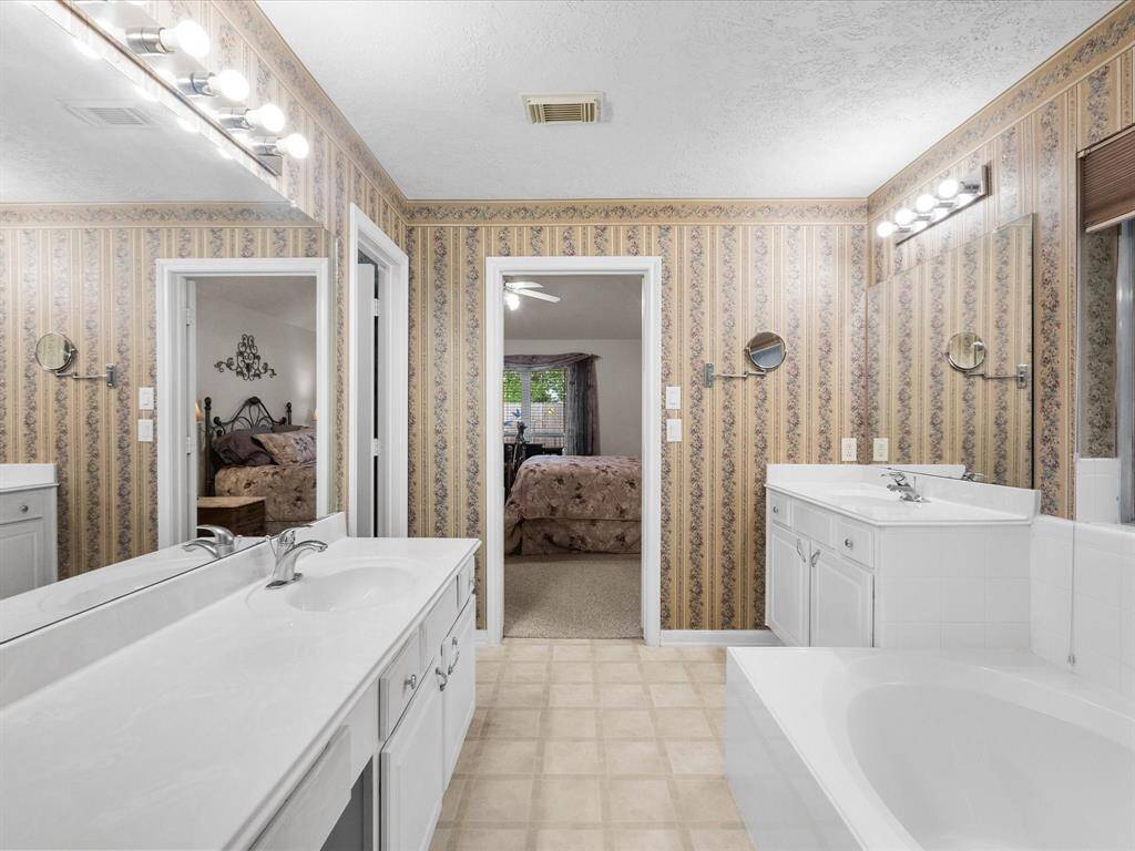 The en suite bathroom features a separate shower and bathtub, dual sinks for added convenience, and a spacious walk-in closet—all designed for comfort and ease.