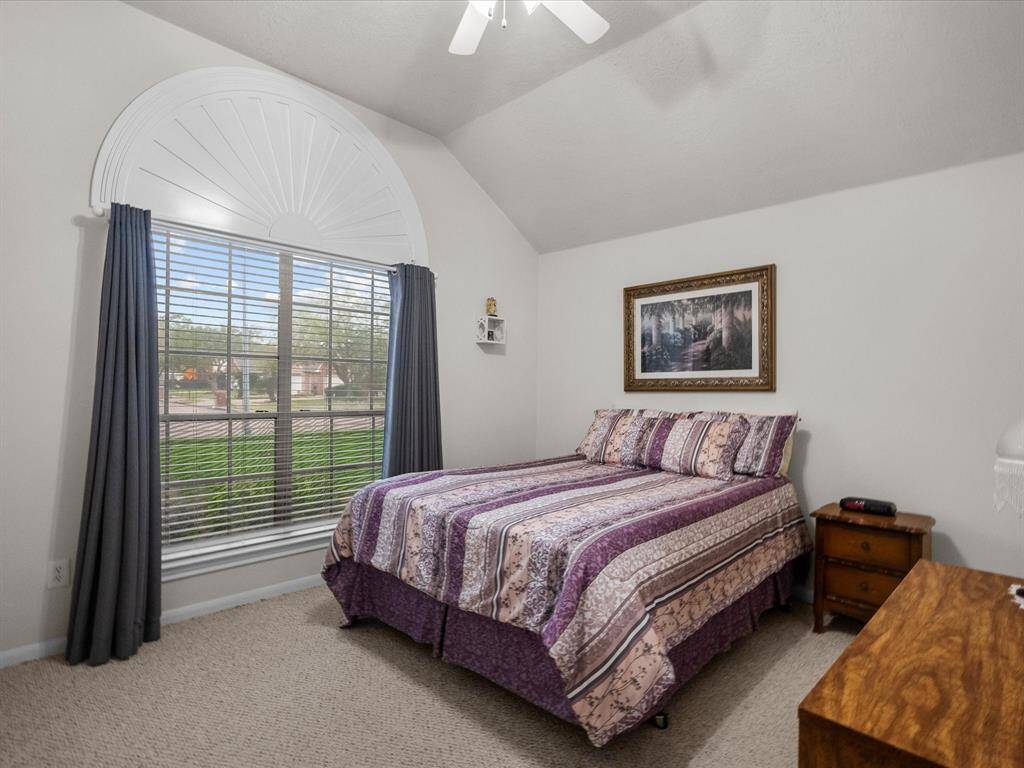Bedroom 2 is located at the front of the home, featuring a large window that brings in natural light and a generously sized closet for ample storage.
