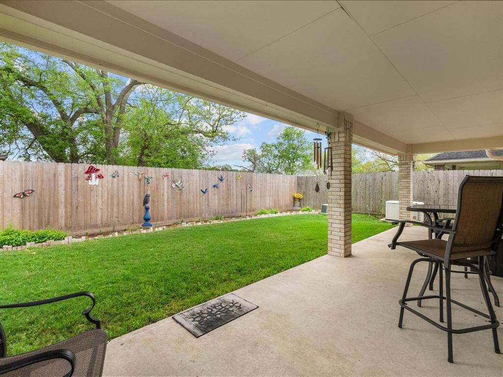 A spacious covered back slab stretches across the rear of the home, providing plenty of room for outdoor entertaining, dining, or weekend grilling.