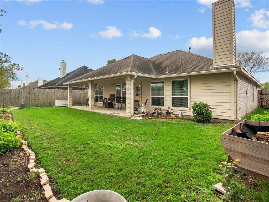 Raised gardens and flowerbeds add charm and functionality to the outdoor space—perfect for garden lovers and those who enjoy a touch of nature at home.