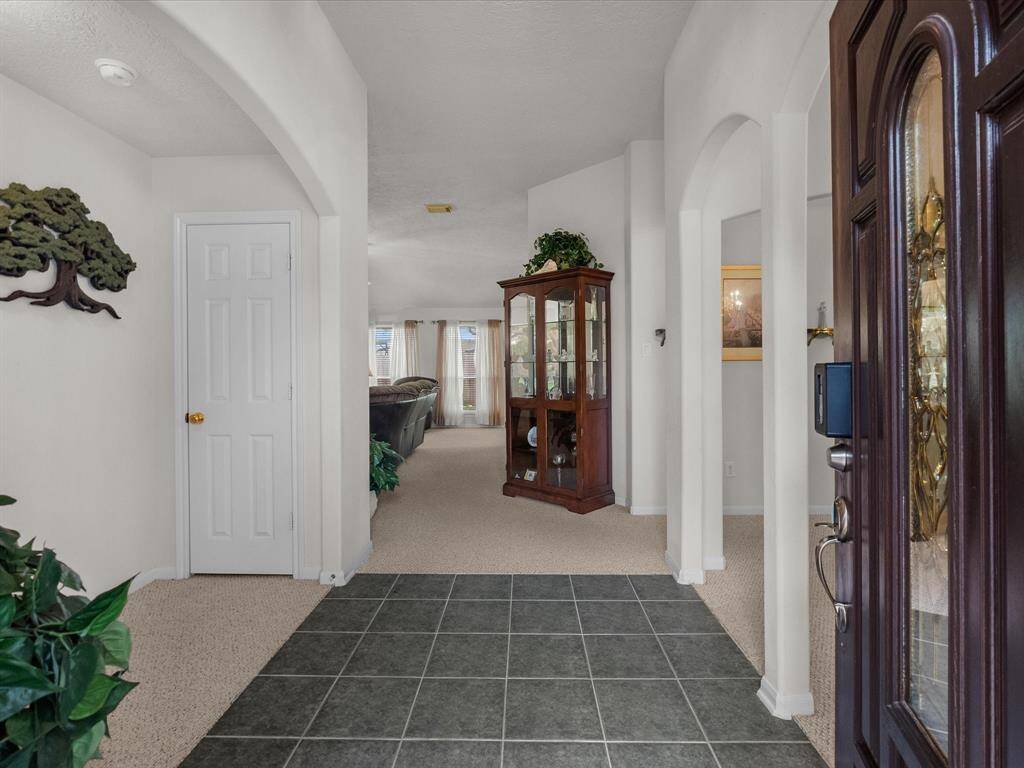 Stepping through the front door, you're greeted by a bright entryway with a formal dining room to the right and the family room unfolding just ahead.