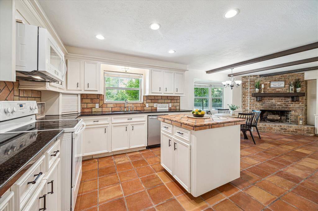 Kitchen and cozy dining room with woodburning fireplace!